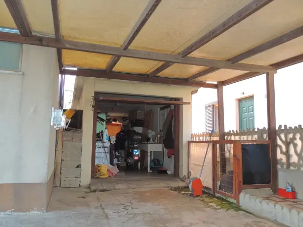 Una vista della corte della palazzina con garage coperto.